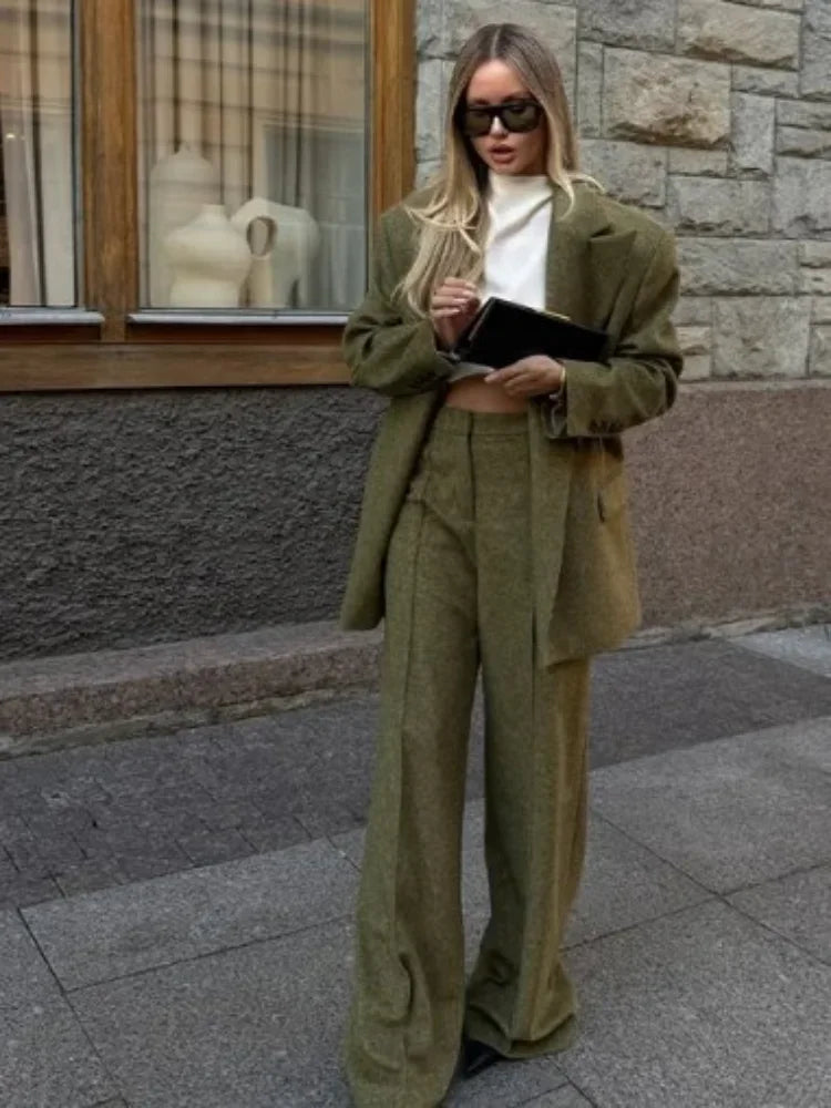 Ensemble blazer vert avec épaulettes et pantalon à jambes droites en tissu doux et résistant.