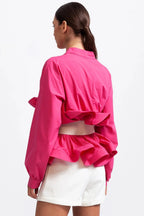Blouse rose pour femme avec volants et manches volumineuses, en coton léger.