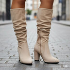 Bottes genou en beige, talon bloc, en simili cuir, avec un design plissé et un coupe moderne.
