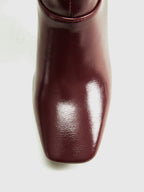 Bottes hautes marron pour femme, en simili cuir, avec talons carrés modernes.