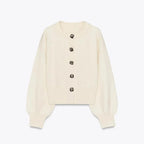 Krémfarbener Cardigan für Damen aus weichem Material, mit stylischen Knöpfen und langen Ärmeln für einen lässigen Look.