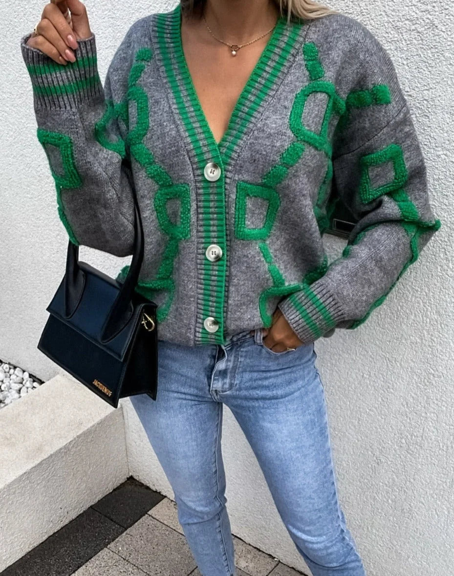 Cardigan femme rose à motifs géométriques, en matière douce, avec boutons sur le devant.