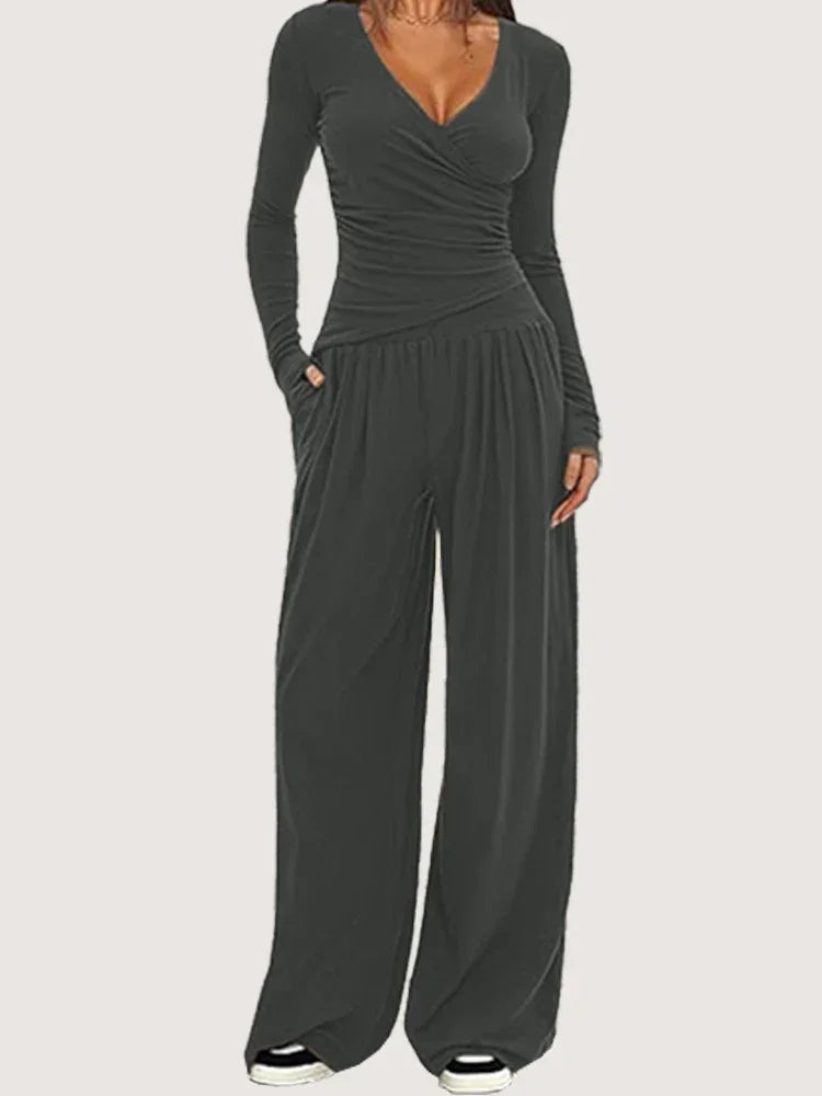 Ensemble sportswear femme noir, composé d'un pantalon ample et d'un haut à manches longues en tissu respirant.
