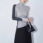 Damenoberteil mit Stehkragen und kontrastierenden Ärmeln aus weichem, bequemem Material in zeitlosem Design.