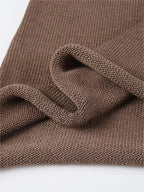 Haut femme tricoté, dos ouvert, manches évasées, design élégant.