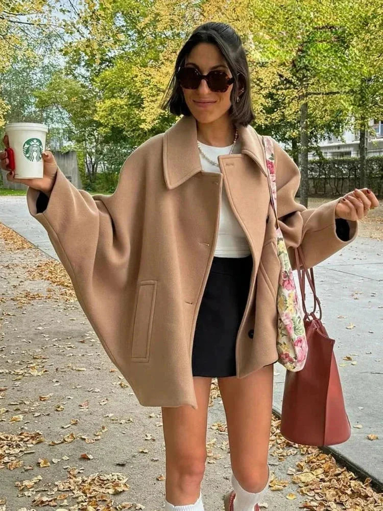 Manteau court oversize beige pour femme avec boutons, en tissu léger et au design décontracté.