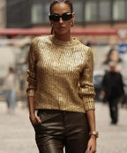 Pull femme doré scintillant à manches longues, en tissu or, adapté pour des occasions festives.