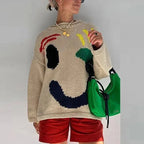 Pull femme oversize bleu marine à manches longues avec motif smiley, en mélange de coton pour un confort optimal.