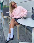 Rosefarbener Oversize-Pullover für Damen aus weichem Material mit langen Ärmeln und lässigem Schnitt.