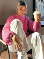 Rosa Damenpullover aus weichem Material, modernes Design mit offenem Rücken für einen lässigen, stilvollen Look.