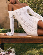 Robe courte en dentelle blanche avec épaules dénudées, délicate, avec motifs floraux et coutures raffinées.