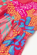 Robe courte rose vif à manches évasées, en tissu léger, avec un motif floral pour un look décontracté d'été.