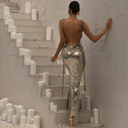 Robe longue argentée métallisée, sans manches, avec une coupe asymétrique et un tissu brillant, idéale pour les soirées.