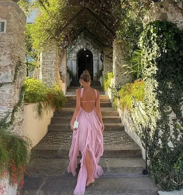 Robe longue sans bretelles en tissu léger, ornée de volants élégants et motifs floraux délicats sur le bas.