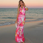 Robe longue rose à nouer dans le dos, col halter, imprimé tropical, idéale pour la plage en été, en tissu léger et fluide.