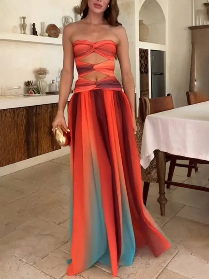 Robe maxi femme en tissu léger dégradé orange, avec un design à dos nu et des bretelles fines. Parfaite pour l'été.