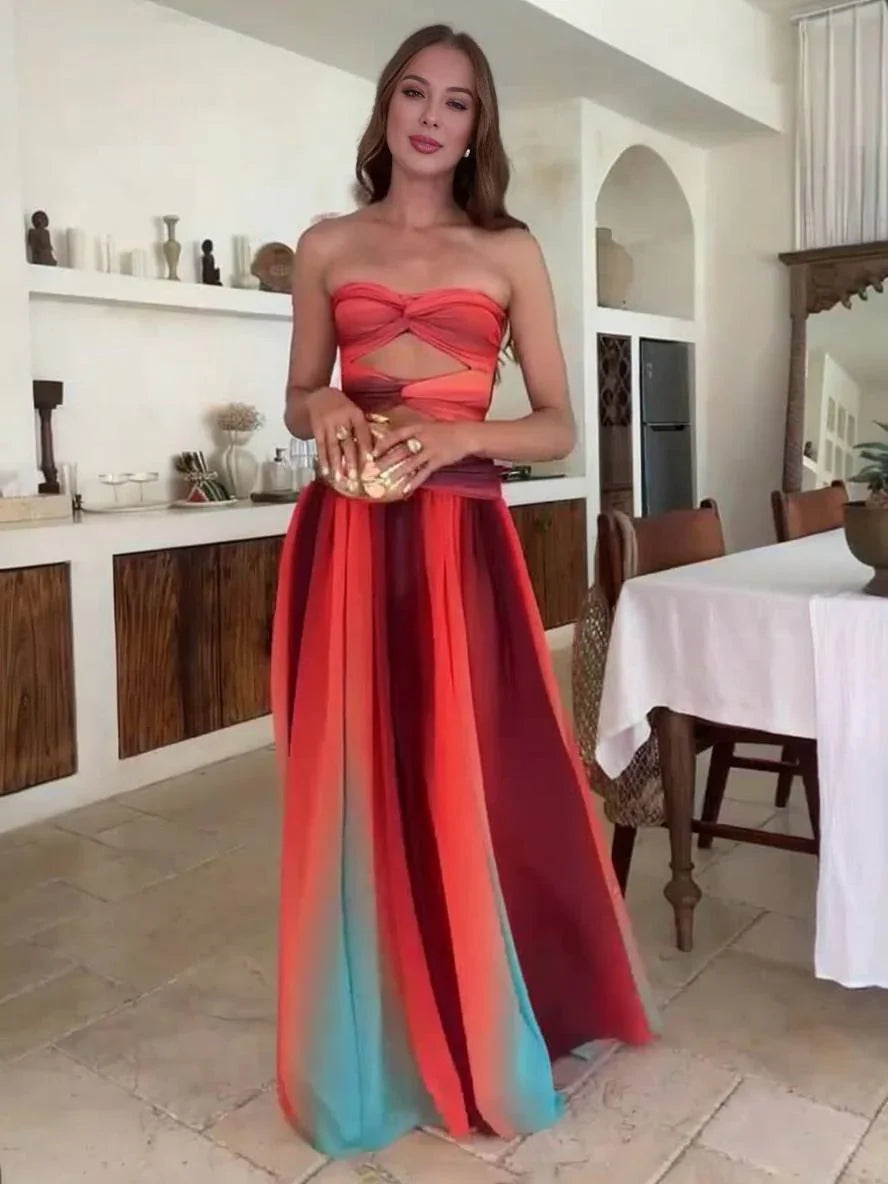 Robe maxi femme en tissu léger, dégradé orange, avec un dos nu et des bretelles fines pour un style élégant et décontracté.