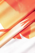 Robe longue fleurie blanche et orange sans bretelles, en tissu léger et estival, idéale pour les journées ensoleillées.