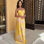 Robe longue à fleurs jaunes sans bretelles, en coton léger, idéale pour les sorties estivales, avec un motif floral vibrant.