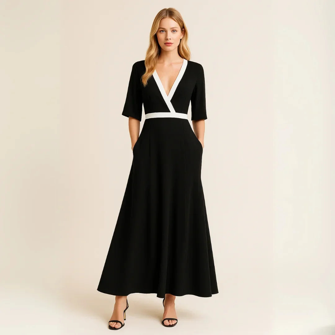 Robe longue fluide en tissu léger, manches mi-longues, bordure contrastée et poches pratiques pour un style décontracté.