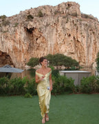 Robe longue jaune à épaules dénudées, en satin, avec pochette assortie, parfaite pour une soirée élégante.