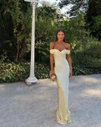 Robe longue jaune à épaules dénudées, en satin, avec pochette assortie. Idéale pour des soirées élégantes.