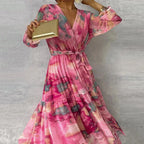 Robe longue longue rose imprimée avec manches longues, ceinture évasée, idéale pour les soirées d'été.