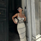 Robe longue moulante en maille écrue, détails ajourés et lanières larges, idéale pour soirées d'été.