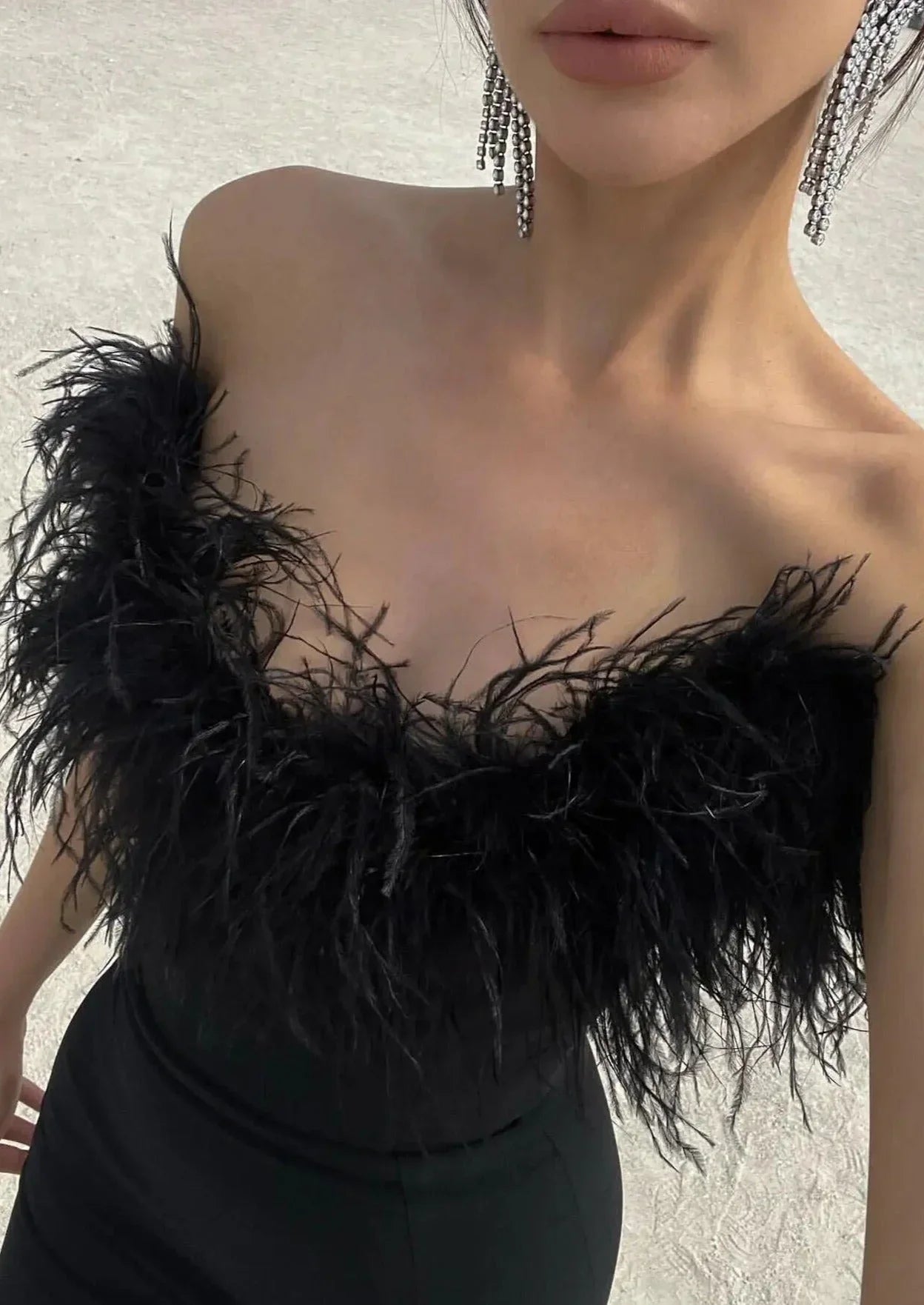 Robe longue noire sans bretelles, en polyester, avec une élégante bordure en plumes à la base pour une touche unique.