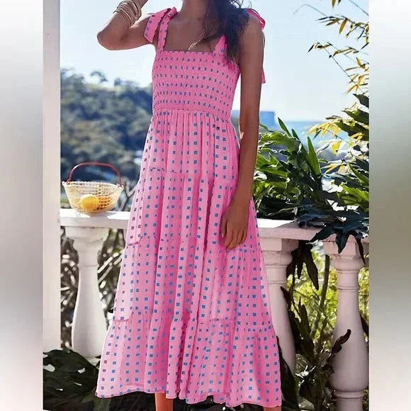 Robe longue rose smockée à bretelles nouées, en coton léger, imprimée d'un motif floral pour l'été.