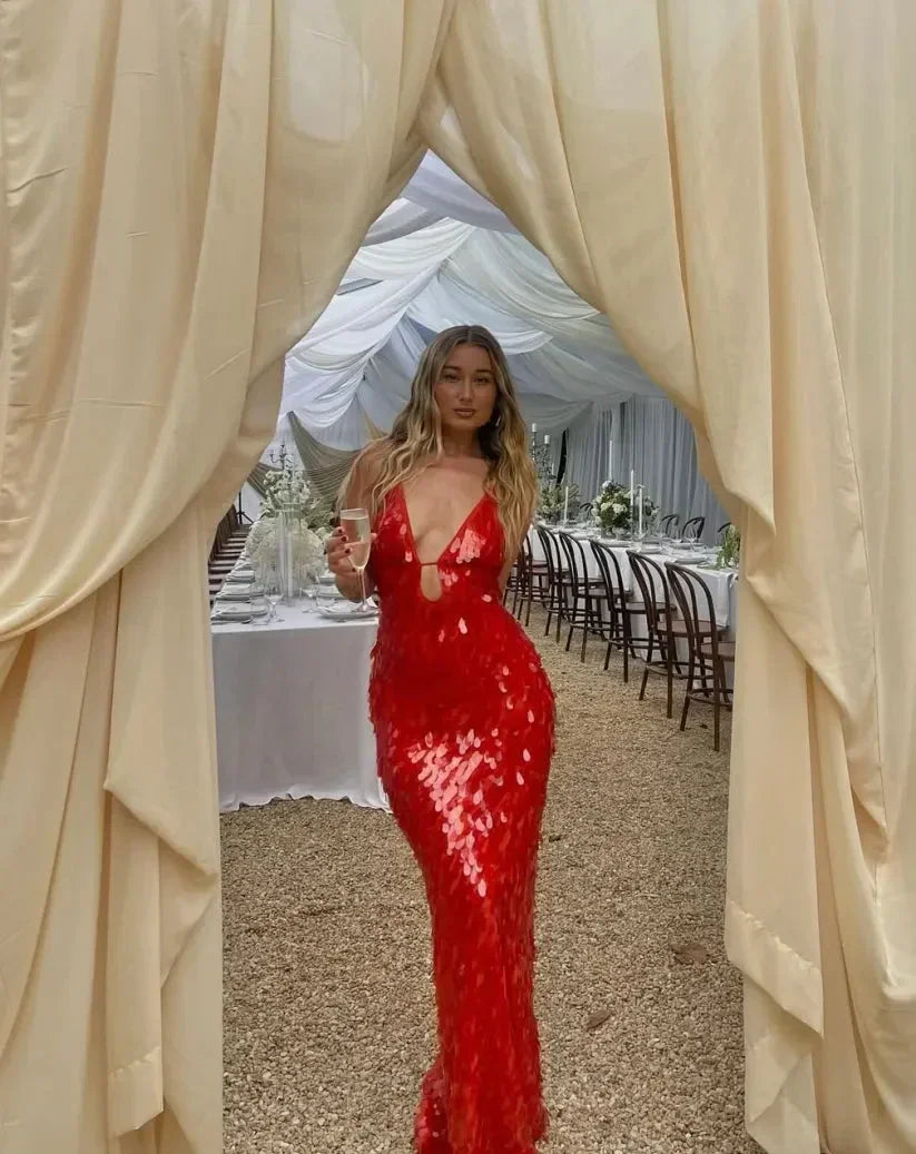 Robe longue rouge sans manches en sequins avec décolleté plongeant, idéale pour les soirées élégantes et festives.