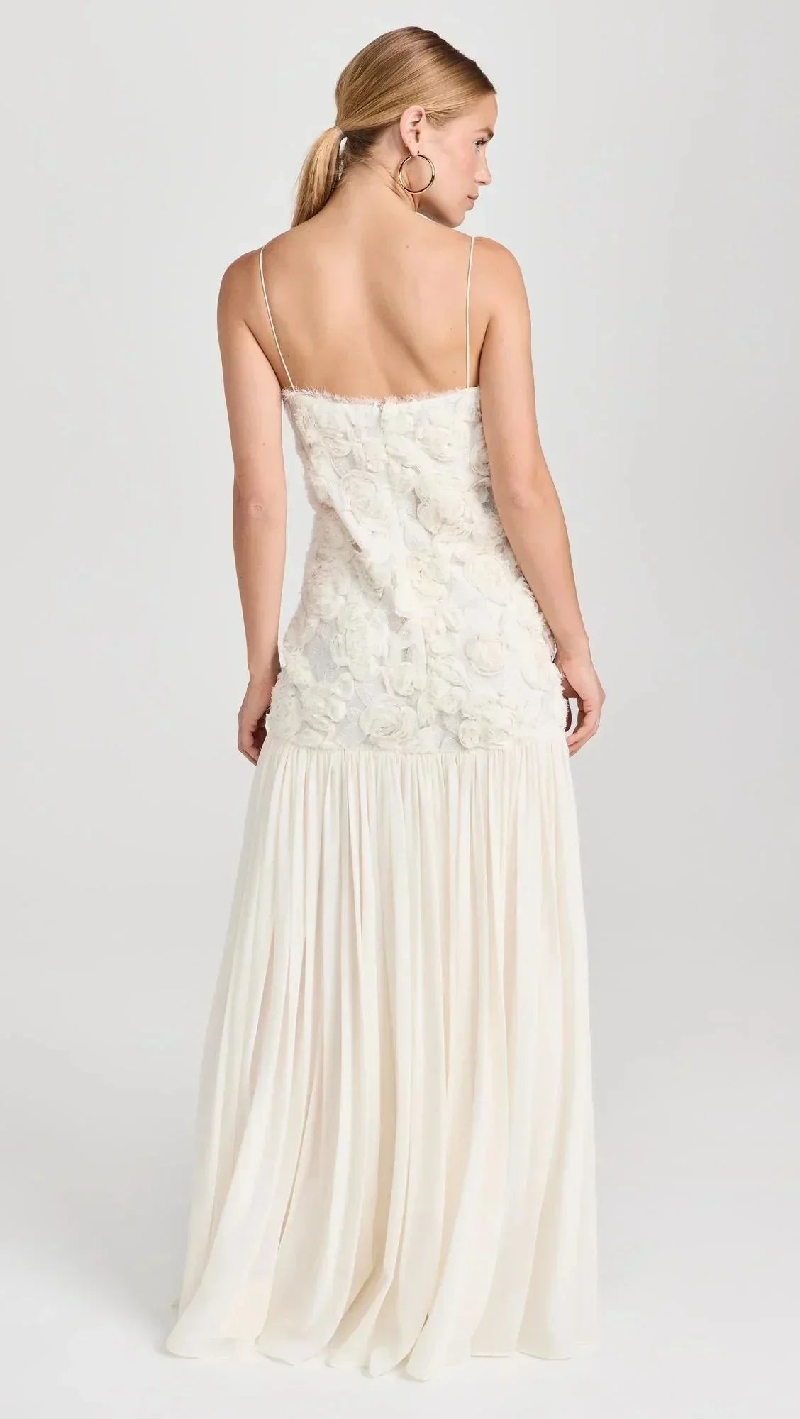 Robe longue sans manches en dentelle avec bretelles fines, alliant élégance et légèreté pour un look raffiné.