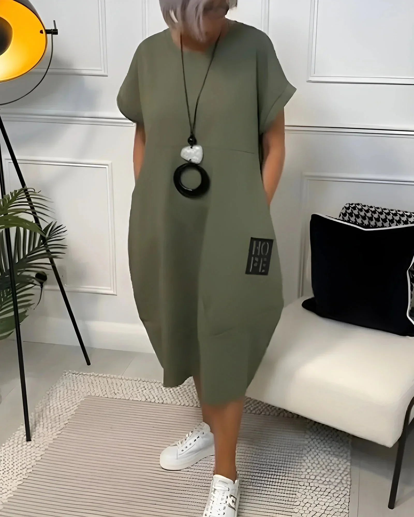 Robe midi ample en tissu fluide, manches courtes, avec poches, idéale pour un look décontracté en toute saison.