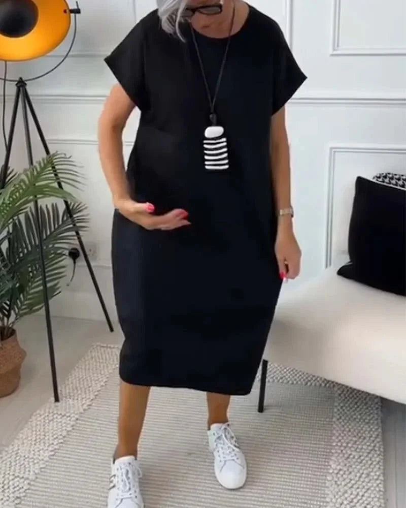 Robe midi ample en tissu fluide, manches courtes, poches pratiques, style décontracté pour toutes les saisons.