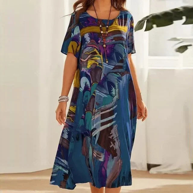 Robe midi ample et fluide, manches courtes, col rond, imprimée, idéale pour l’été et offrant un style modeste.