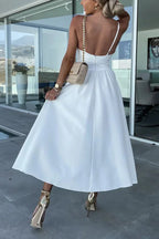 Robe midi décontractée en coton avec découpes, poches pratiques et longue fente, idéale pour un look décontracté.