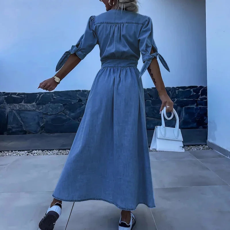 Robe midi en denim bleu avec boutons, manches à nouer et col en V, idéale pour un look décontracté au printemps et été.