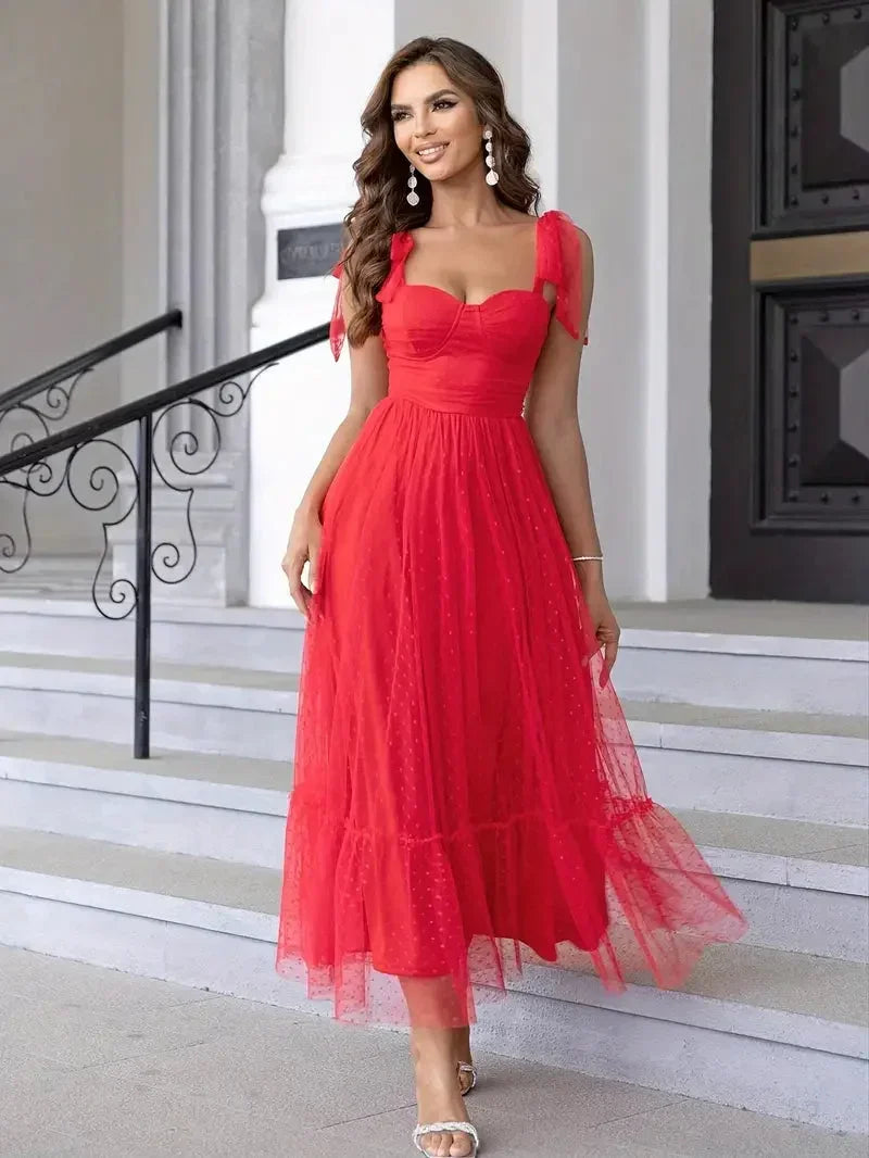 Robe midi femme en mesh sans manches, avec des nœuds décoratifs sur les épaules pour un style élégant et féminin.