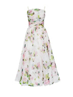 Robe midi fleurie sans manches en coton, col droit, avec un imprimé floral vif, parfaite pour les événements printaniers.