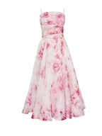 Robe midi fleurie sans manches en tissu léger, col droit et imprimé floral parfait pour événements printaniers et estivaux.