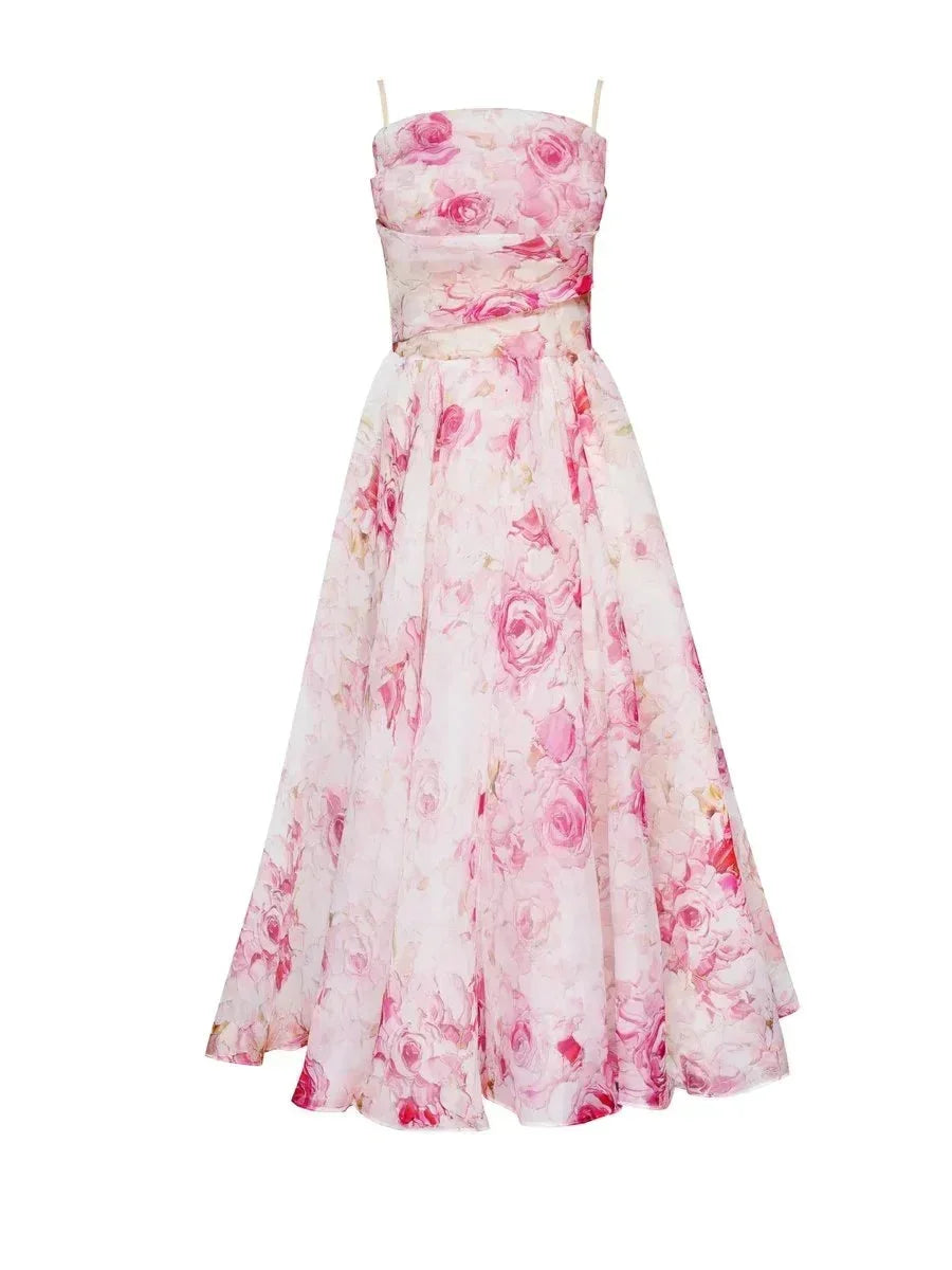 Robe midi fleurie sans manches en tissu léger, col droit et imprimé floral parfait pour événements printaniers et estivaux.