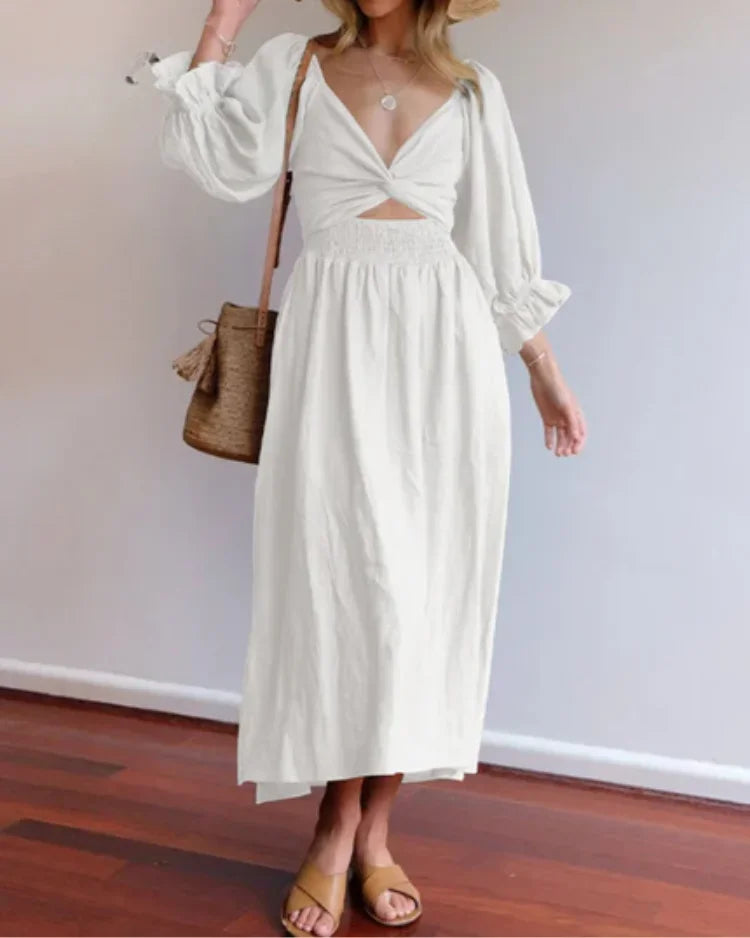 Robe midi portefeuille en tissu fluide avec manches longues et col V, idéale pour un look élégant et confortable.