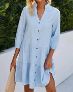 Robe midi vichy en coton, boutons sur le devant, col classique et manches 3/4 évasées, idéale pour le printemps-été.