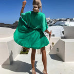 Robe courte fluide en matière légère, col V, cache-cœur avec manches courtes, parfaite pour des journées d'été à la plage.