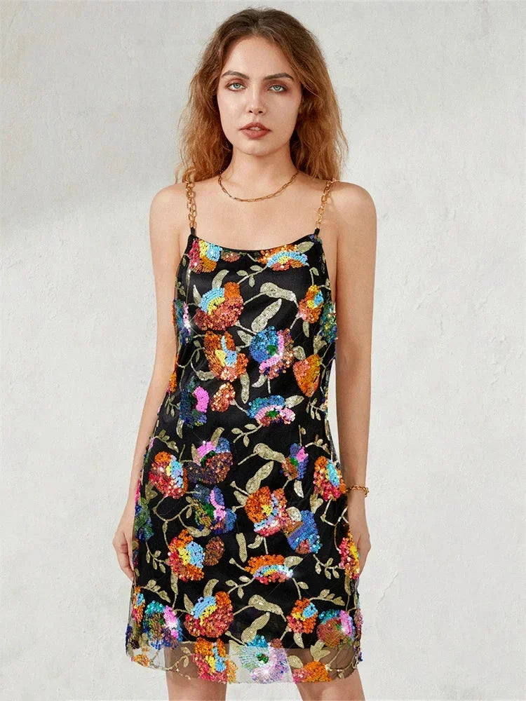 Robe courte à bretelles, tissu scintillant ajusté, motif coloré idéal pour soirées, style élégant et moderne.