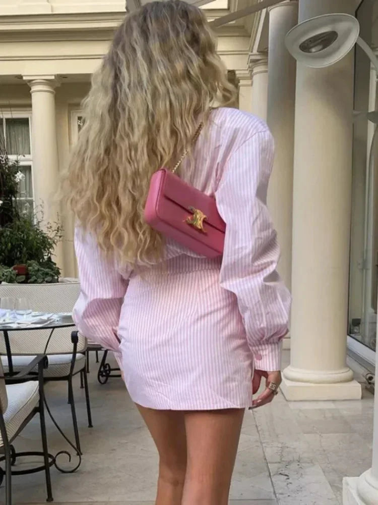 Robe courte rayée rose en coton léger, manches longues, fente latérale idéale pour une journée printanière.