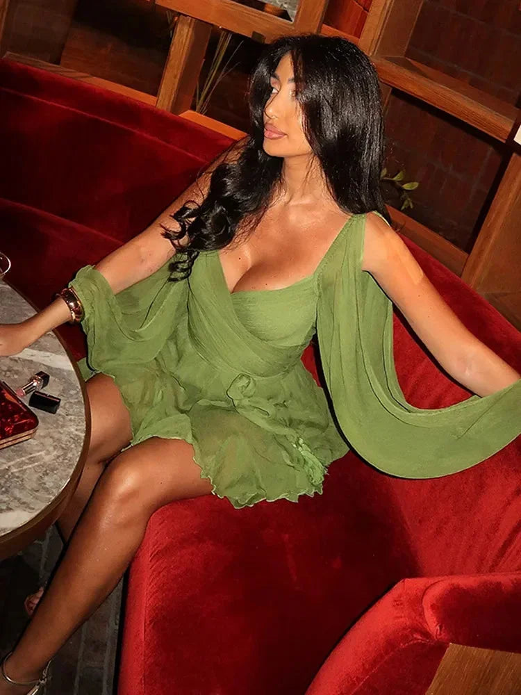 Robe courte verte en tissu léger, avec manches bouffantes et ourlet à volants, parfaite pour les soirées. Taille cintrée.