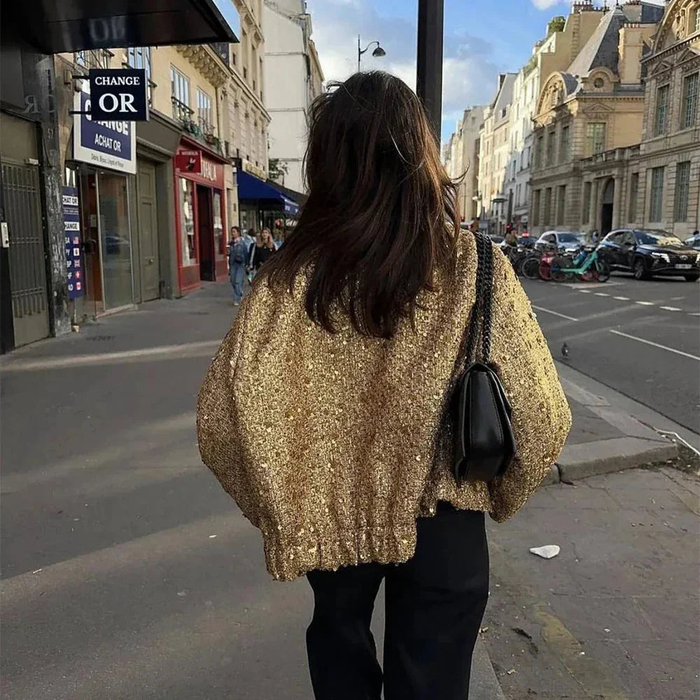 Veste femme dorée à paillettes, coupe élégante et tissu doux, adaptée pour les occasions festives.