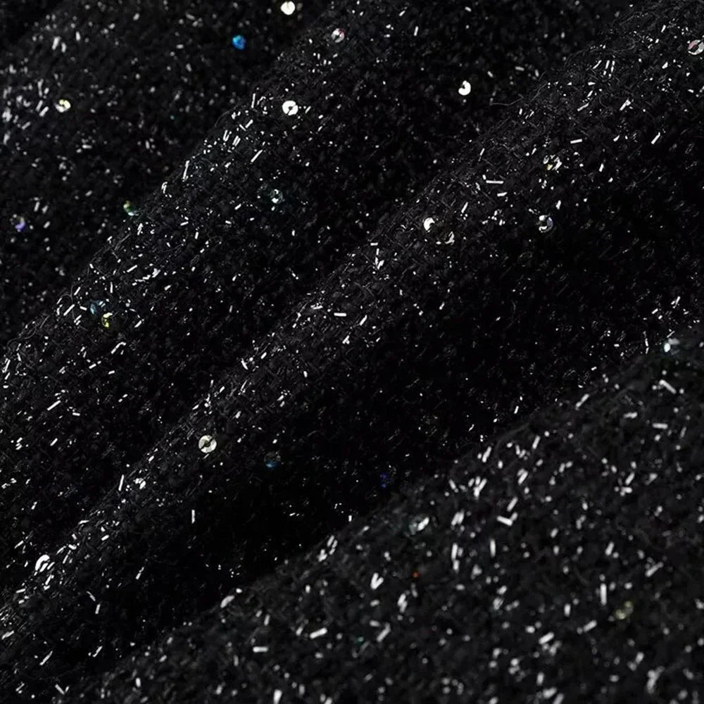 Veste femme à paillettes, coupe ajustée, tissu léger, idéale pour des occasions élégantes.