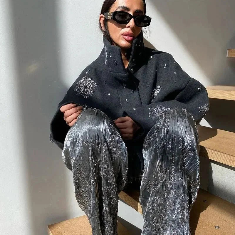 Veste femme gris avec col montant, manches chauve-souris et broderie, adaptée pour des occasions décontractées.